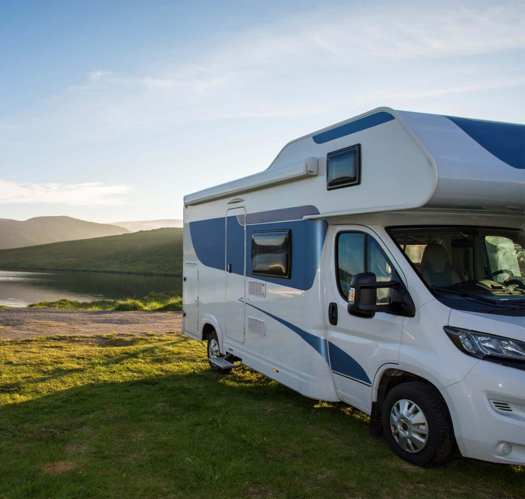Campervan parked by lake