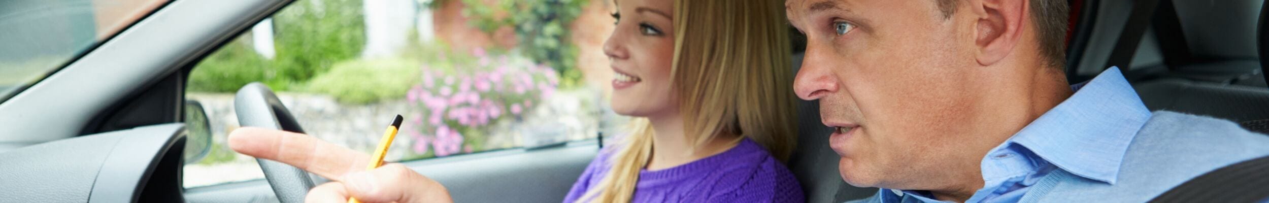 Girl learning to drive with instructor