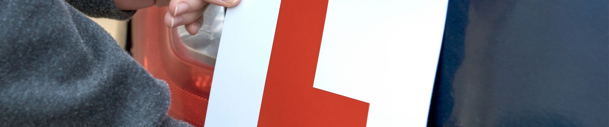 Learner Plate being put on car