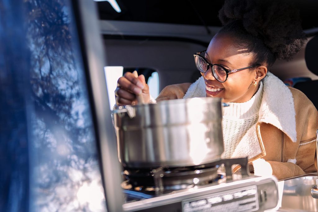 Woman cooking in motorhome