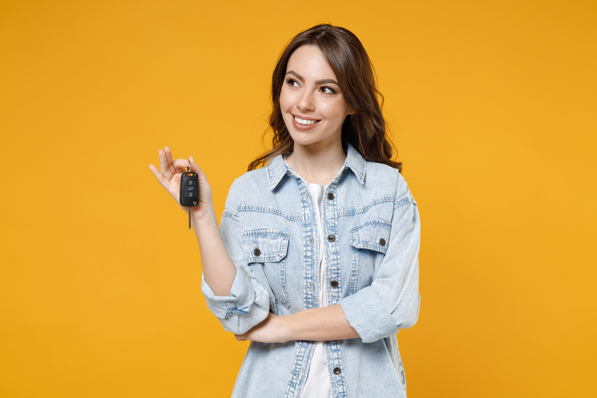 woman holding keys to new car