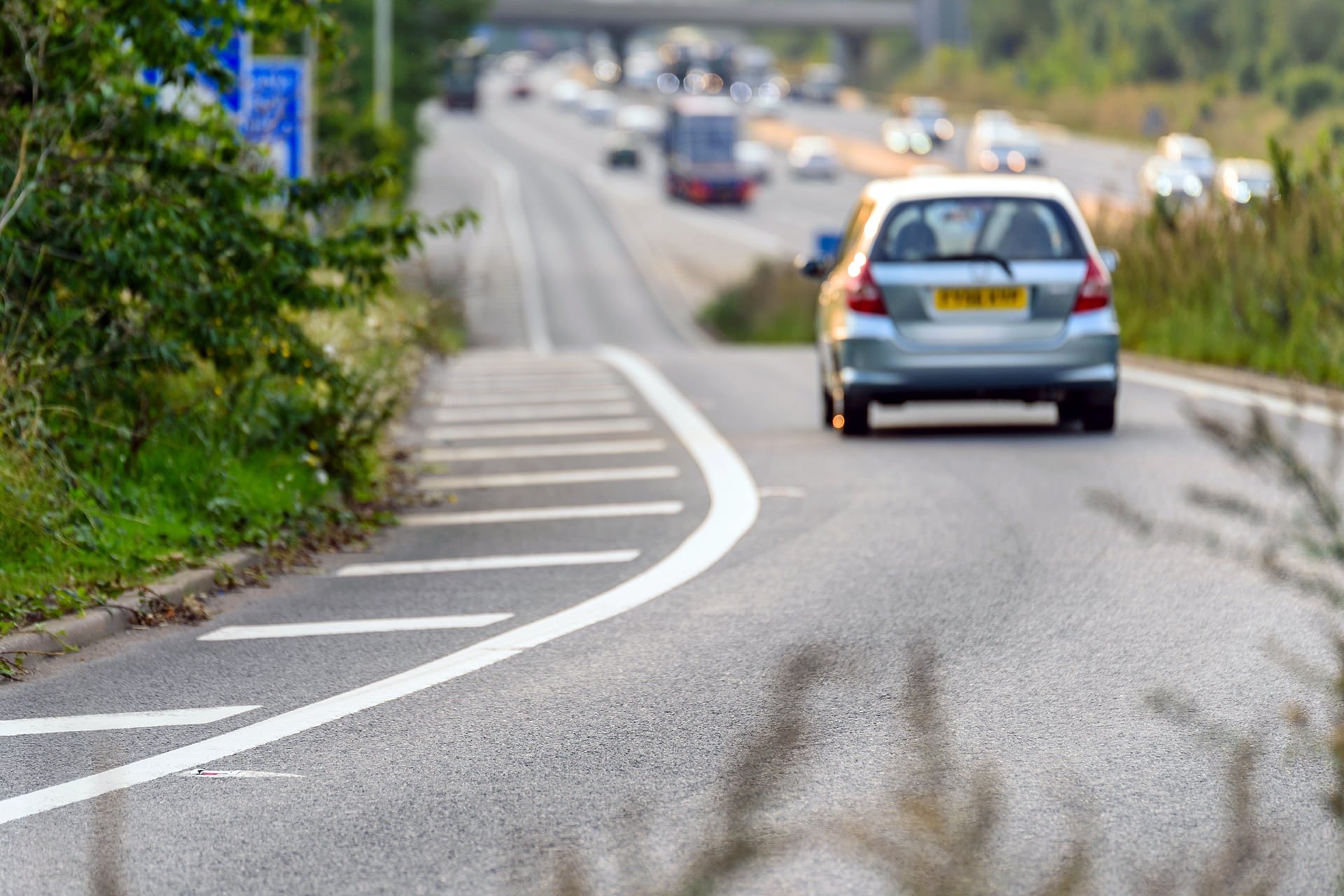car driving down the slip road to the motorway