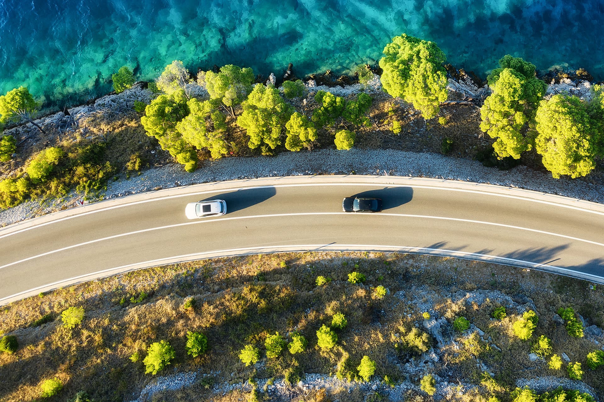 Cars driving on a coastal road in Europe