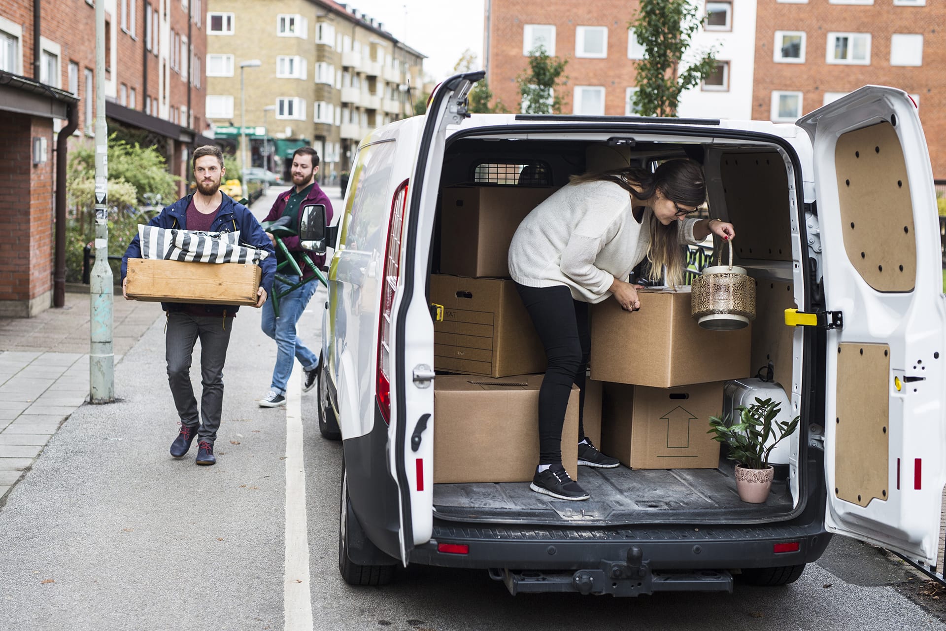 Friends helping move using a van