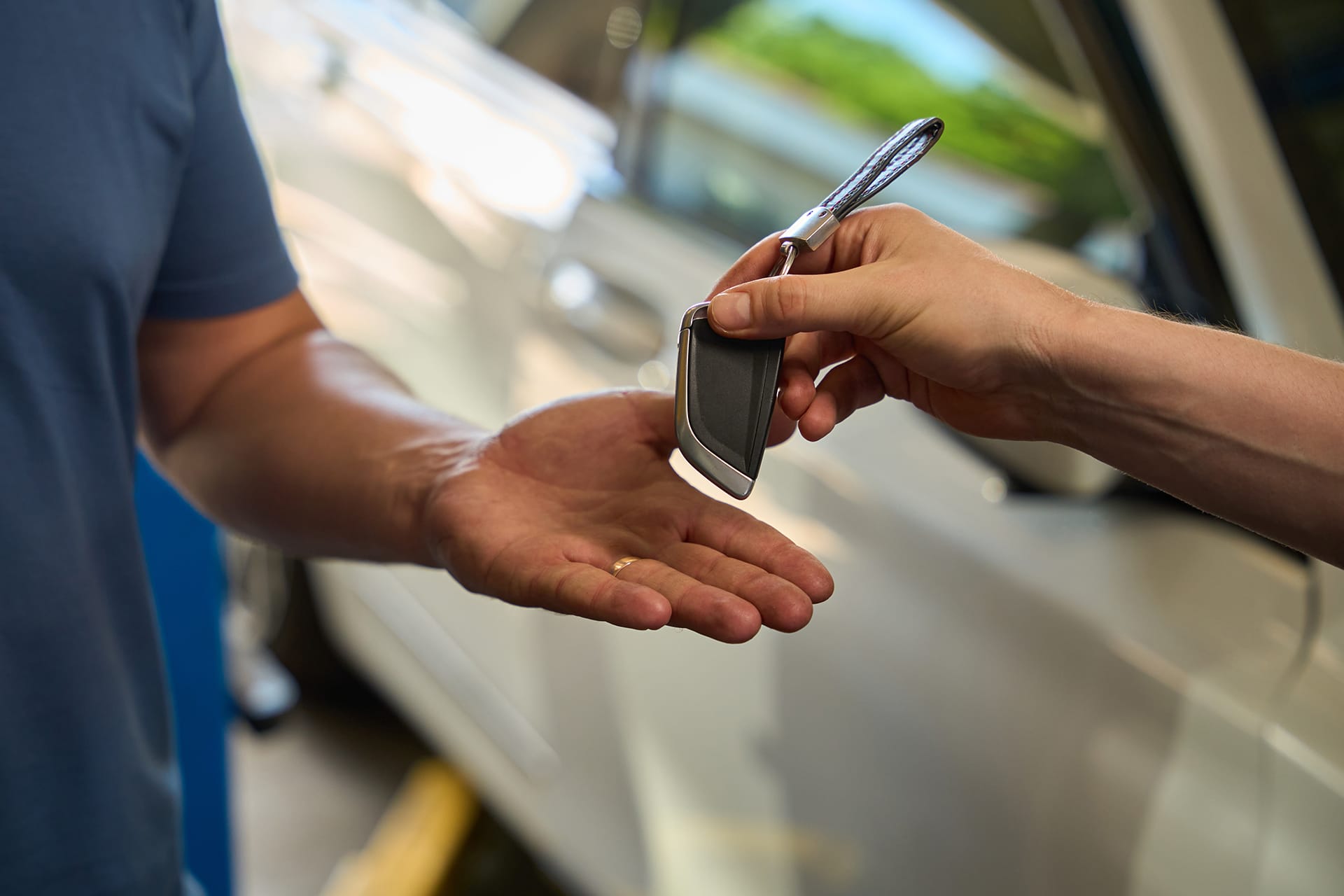 Somebody handing over car keys once purchased.