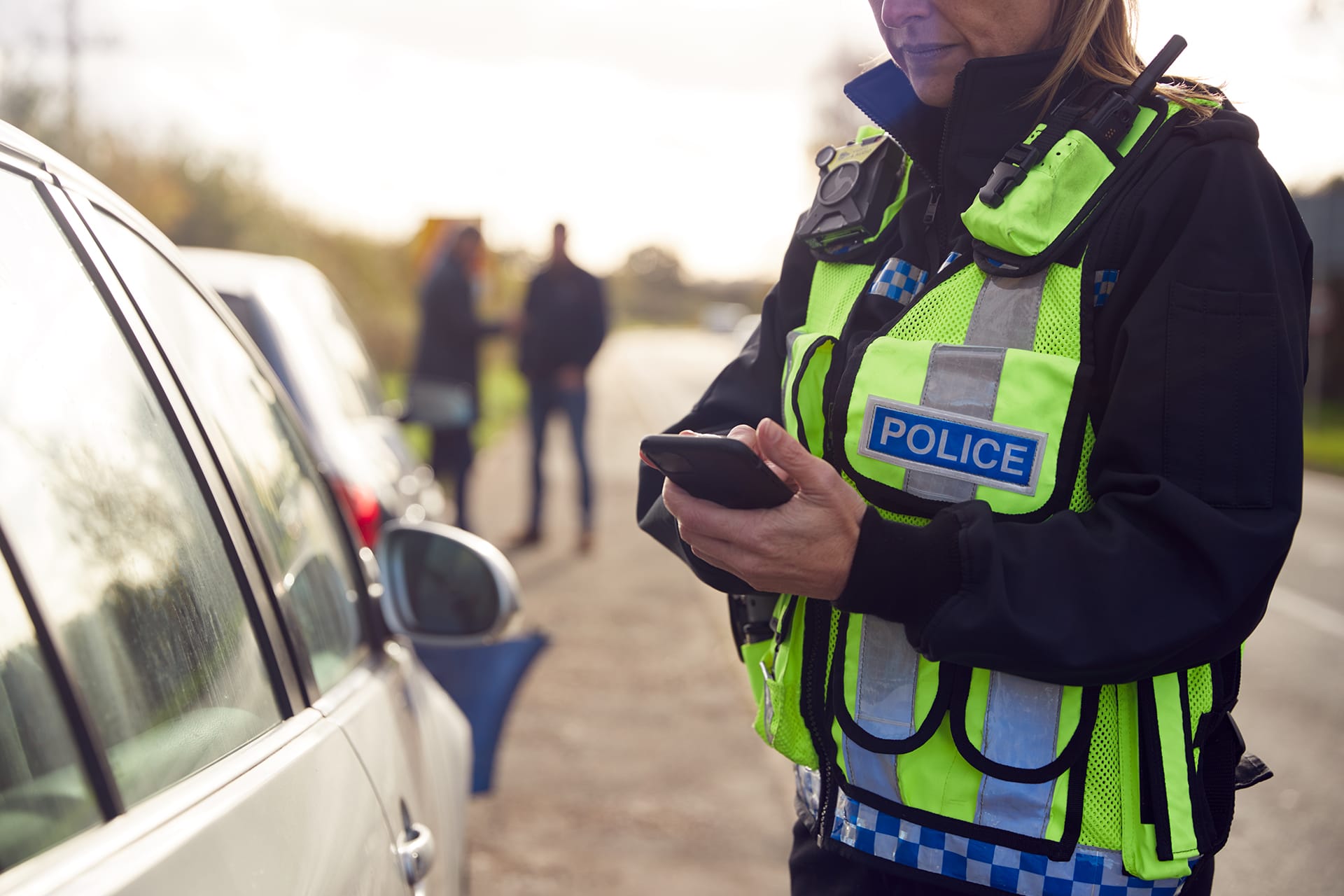Police officer next to car